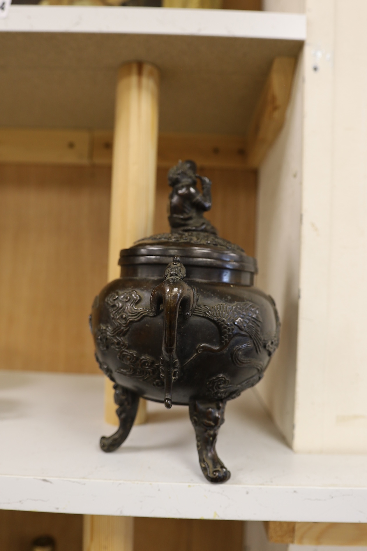 A Japanese bronze dragon handled censer with figural finial to cover, Meiji period, 24cm high. Condition - good